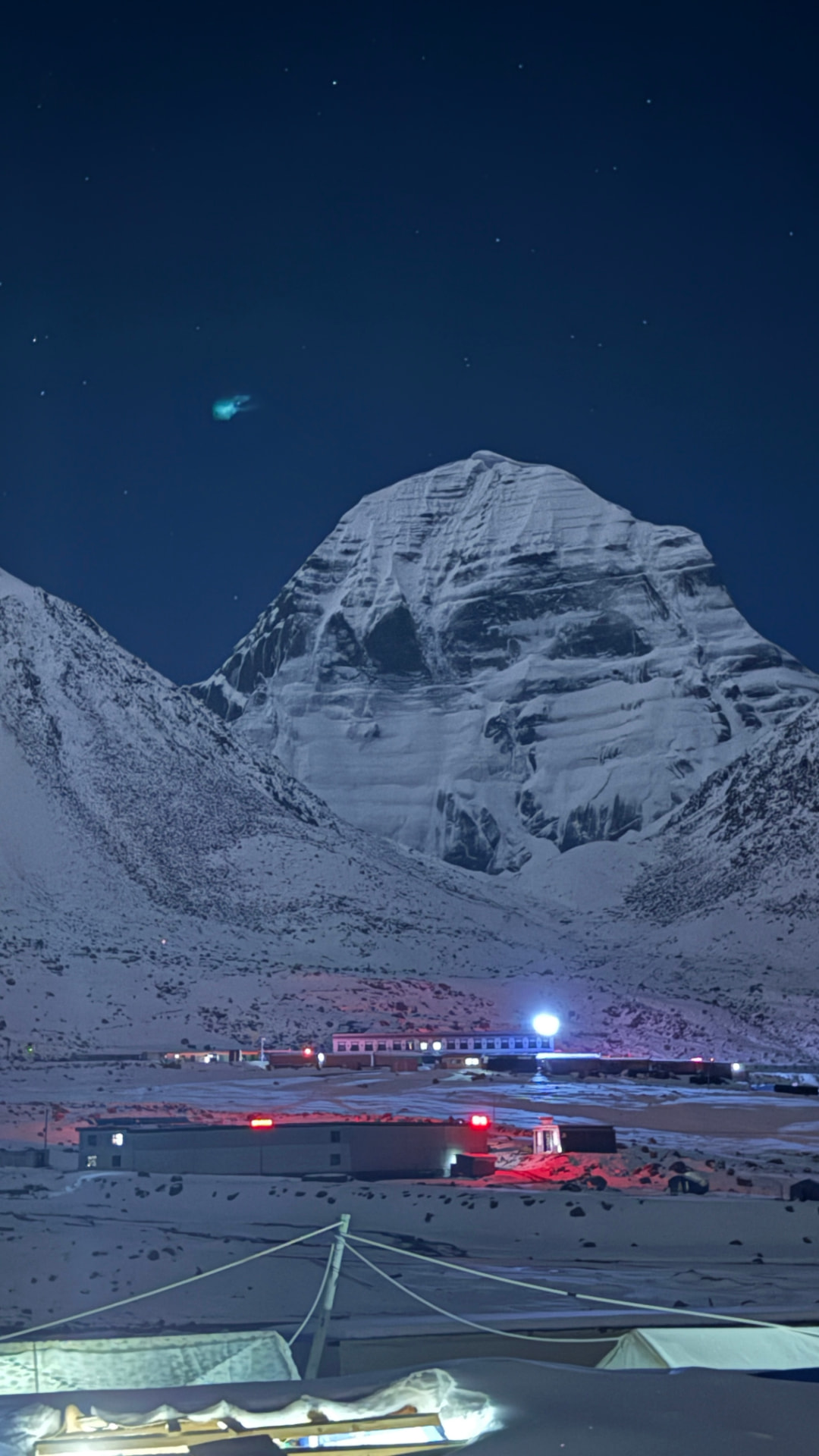 Mount Kailash beneath a starry night sky above Darchen